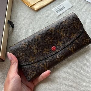 Authentic Louis Vuitton wallet in monogram canvas with a red interior
